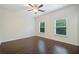 Spacious bedroom featuring hardwood floors, two windows, and a ceiling fan at 3231 Chutney Ct, Avondale Estates, GA 30002