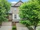 Charming townhome showcasing a well-manicured lawn, a garage, and a beautiful architectural design at 3231 Chutney Ct, Avondale Estates, GA 30002