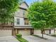 Inviting townhome features neutral colors, attached garages, lush trees, and a welcoming facade at 3231 Chutney Ct, Avondale Estates, GA 30002