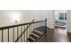 Hallway with hardwood floors and wooden banister, leading to comfortable bedroom at 3231 Chutney Ct, Avondale Estates, GA 30002