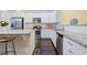Bright kitchen featuring white cabinets, granite counters, stainless appliances, and wood floors at 3231 Chutney Ct, Avondale Estates, GA 30002