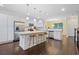 Bright kitchen features white cabinets, stainless steel appliances, granite countertops, and a large central island with stool seating at 3231 Chutney Ct, Decatur, GA 30032