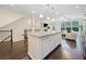Modern kitchen with a large island, stainless appliances, pendant lighting, and a view to living room at 3231 Chutney Ct, Avondale Estates, GA 30002
