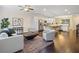 Open-concept floorplan with living room leading to kitchen, showcasing hardwood floors and neutral decor at 3231 Chutney Ct, Avondale Estates, GA 30002