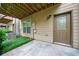 View of the back patio with a door and some greenery, perfect for enjoying the outdoors at 3231 Chutney Ct, Avondale Estates, GA 30002