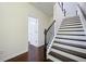 Staircase with hardwood steps, white risers, and dark railing leading to the upper level of the home at 3231 Chutney Ct, Avondale Estates, GA 30002