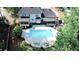 Aerial view displays the pool, lounge area, pergola covered deck and rear of house at 4985 Miller Sw Rd, Lilburn, GA 30047