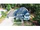 Aerial view of a charming two-story home with a landscaped front yard and driveway at 4985 Miller Sw Rd, Lilburn, GA 30047