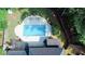Aerial view of a backyard with a swimming pool, pergola, and lush greenery at 4985 Miller Sw Rd, Lilburn, GA 30047