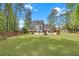 Spacious backyard with a swimming pool, pergola, and landscaped lawn at 4985 Miller Sw Rd, Lilburn, GA 30047