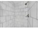 Modern bathroom shower showcasing elegant white subway tile and bronze fixtures at 4985 Miller Sw Rd, Lilburn, GA 30047
