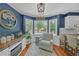 Cozy breakfast nook with lots of light, comfortable chair, hardwood flooring and a view to the backyard at 4985 Miller Sw Rd, Lilburn, GA 30047