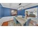 Dining room with blue walls next to the living room featuring a fireplace and comfortable furnishings at 4985 Miller Sw Rd, Lilburn, GA 30047