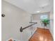 Upstairs hallway with hardwood floors and decorative trim at 4985 Miller Sw Rd, Lilburn, GA 30047