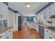 Spacious kitchen with hardwood floors, white cabinets, and stainless steel appliances at 4985 Miller Sw Rd, Lilburn, GA 30047