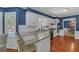 Open concept kitchen with bar seating, sleek countertops, and hardwood floors at 4985 Miller Sw Rd, Lilburn, GA 30047