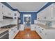 Well-lit kitchen features white cabinets, stainless steel appliances, and granite countertops at 4985 Miller Sw Rd, Lilburn, GA 30047