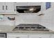 Modern kitchen featuring a gas stovetop and white subway tile backsplash at 4985 Miller Sw Rd, Lilburn, GA 30047