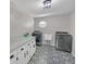 Modern laundry room with stylish tile floors, new washer and dryer, and extra cabinet space at 4985 Miller Sw Rd, Lilburn, GA 30047