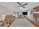 Comfortable living room featuring a brick fireplace, hardwood floors, and neutral decor at 4985 Miller Sw Rd, Lilburn, GA 30047