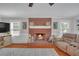 Inviting living room with a cozy brick fireplace, hardwood floors, and ample natural light at 4985 Miller Sw Rd, Lilburn, GA 30047