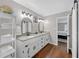 Modern main bathroom features a double vanity with granite countertop, towel rack and an entry door to bedroom at 4985 Miller Sw Rd, Lilburn, GA 30047