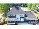 Aerial view of the home's rear exterior showing a screened porch and deck with pergola at 4985 Miller Sw Rd, Lilburn, GA 30047