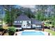 View of the pool, deck with pergola, screened porch and rear of this beautiful home at 4985 Miller Sw Rd, Lilburn, GA 30047