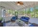 Cozy screened porch with comfortable seating and views of the landscaped backyard at 4985 Miller Sw Rd, Lilburn, GA 30047