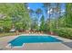 Outdoor swimming pool with lounge chairs and a landscaped backyard at 4985 Miller Sw Rd, Lilburn, GA 30047