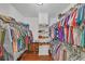 Spacious walk-in closet with ample storage and organization system for clothes and shoes at 4985 Miller Sw Rd, Lilburn, GA 30047