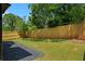 A view of the backyard, which has a privacy fence and a mix of grass and gravel areas at 88 Cleveland Unit B Se St, Atlanta, GA 30316