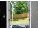 A view of the backyard through the open, modern glass panel back door at 88 Cleveland Unit B Se St, Atlanta, GA 30316
