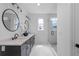 Elegant bathroom features double vanity with modern fixtures, quartz counters, stylish mirrors and a glass-enclosed shower at 88 Cleveland Unit B Se St, Atlanta, GA 30316