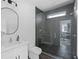 Bathroom featuring a glass shower with dark tile, and a modern white vanity at 88 Cleveland Unit B Se St, Atlanta, GA 30316