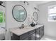Elegant bathroom featuring double vanity with quartz countertop, black fixtures, circular mirrors and walk-in shower at 88 Cleveland Unit B Se St, Atlanta, GA 30316