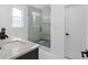 Modern bathroom features walk-in shower with rainfall shower head, stone floor and sleek vanity with marble countertop at 88 Cleveland Unit B Se St, Atlanta, GA 30316