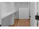 Bright walk-in closet with wood floor and white shelving for optimal storage at 88 Cleveland Unit B Se St, Atlanta, GA 30316