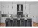Kitchen featuring a kitchen island with bar seating, white cabinets and black hardware and backsplash at 88 Cleveland Unit B Se St, Atlanta, GA 30316
