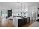 Open concept kitchen with a large island, stainless steel appliances, and view of the living room and fireplace at 88 Cleveland Unit B Se St, Atlanta, GA 30316
