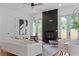 Bright living room featuring a fireplace with black marble accent wall and comfortable contemporary seating at 88 Cleveland Unit B Se St, Atlanta, GA 30316