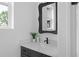 Powder room featuring a vanity with a dark cabinet and white countertop, a mirror and a modern faucet at 88 Cleveland Unit B Se St, Atlanta, GA 30316