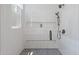 Bright shower features hexagon tile floor, built-in shelves, a rainfall shower head and a clear glass door at 88 Cleveland Unit B Se St, Atlanta, GA 30316