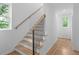 Bright staircase featuring hardwood treads, black metal railings, and white risers and walls at 88 Cleveland Unit B Se St, Atlanta, GA 30316