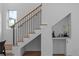 Modern staircase features wood treads, black metal railing and built-in shelving with decor for added elegance at 88 Cleveland Unit B Se St, Atlanta, GA 30316