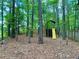 Wooded backyard featuring a fun playground with a slide and fort, creating an adventurous space for children at 1093 Spruce Creek Ln, Lawrenceville, GA 30045