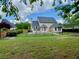 Spacious backyard featuring a well-maintained lawn and secure black metal fence, perfect for outdoor activities at 1093 Spruce Creek Ln, Lawrenceville, GA 30045