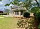 Landscaped backyard with well-maintained lawn and charming sunroom area, perfect for relaxation and outdoor living at 1093 Spruce Creek Ln, Lawrenceville, GA 30045