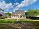 Large backyard with lush green grass and a black metal fence, providing a safe and picturesque outdoor space at 1093 Spruce Creek Ln, Lawrenceville, GA 30045