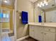 Bright bathroom featuring vanity, mirror, and access to the shower at 1093 Spruce Creek Ln, Lawrenceville, GA 30045